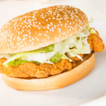 Pan-fried chicken filet sandwich on a soft bun with crispy golden chicken