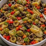Homemade olive salad with green olives, black olives, artichoke hearts, peppers, and fresh parsley
