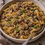 Creamy ground beef stroganoff with mushrooms and egg noodles in a skillet