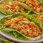 Buffalo chicken lettuce wraps made with spicy chicken, celery, carrots, and butter lettuce