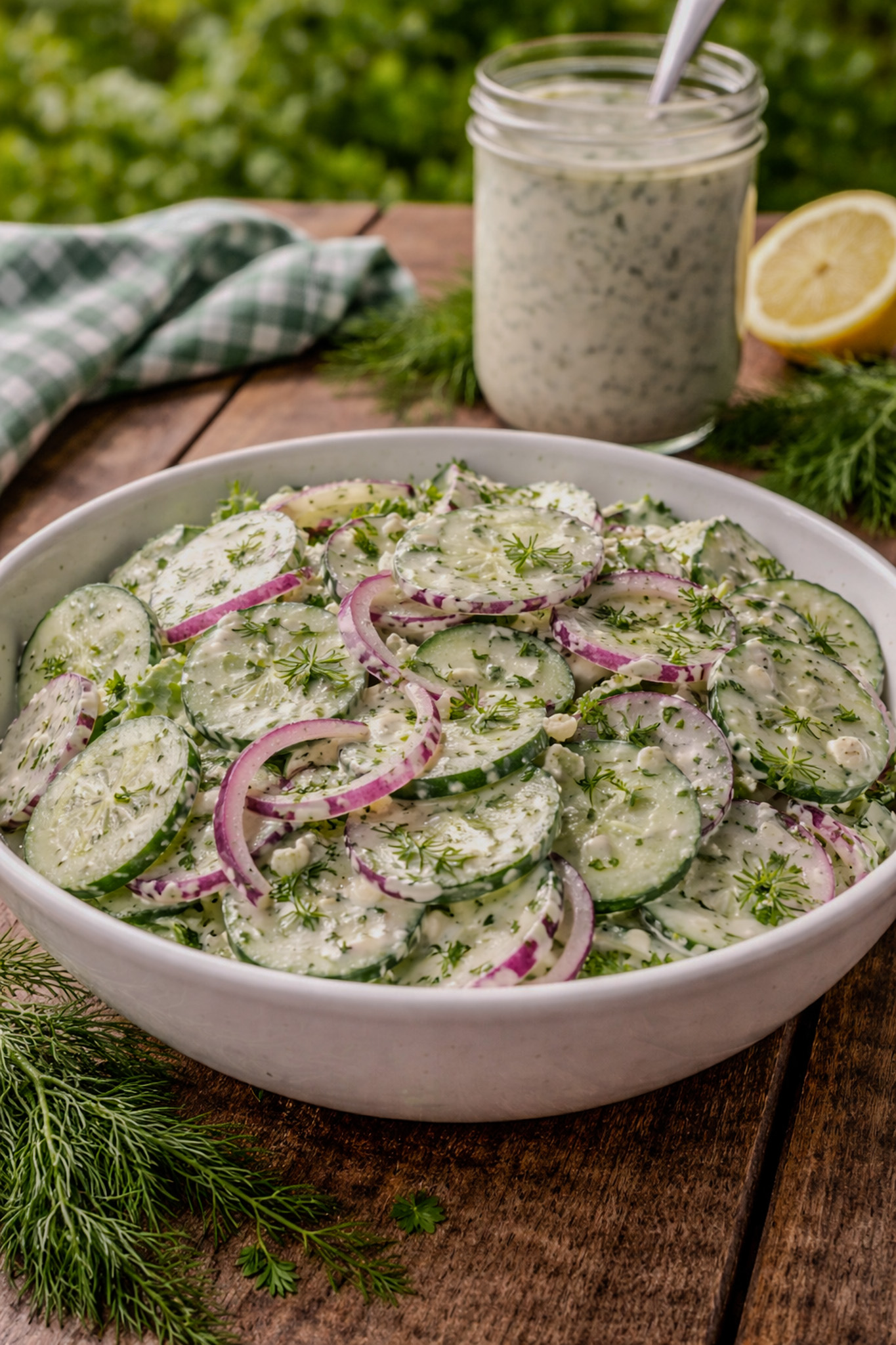 Creamy cucumber salad with fresh dill and red onion in a bowl