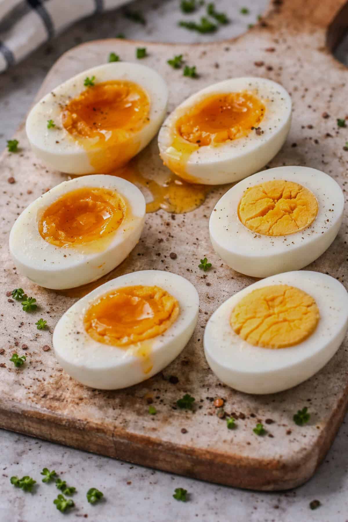Soft, jammy, and hard-boiled eggs sliced in half showing different yolk textures.