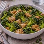 Healthy chicken and broccoli stir fry cooked in a skillet with sesame oil and honey garlic sauce