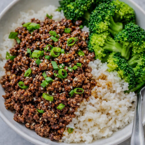Korean ground beef and broccoli served over rice with green onions and sesame seeds