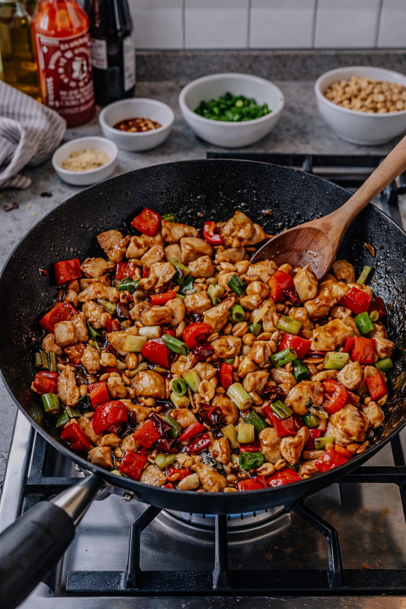 Healthy Kung Pao chicken with peanuts, red peppers, and celery in a skillet