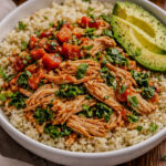 Instant Pot salsa chicken served over cauliflower rice with avocado slices in a healthy bowl