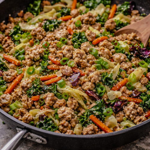 Ground turkey stir fry with ginger, garlic, and Asian vegetables cooked in a skillet
